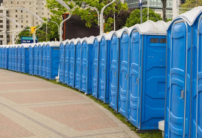 a row of portable restrooms set up for a large athletic event, allowing participants and spectators to easily take care of their needs in Hope Valley